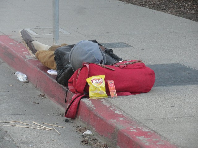 Homeless person In Berkeley California with chips and crackers from The Little Way Homeless Outreach
